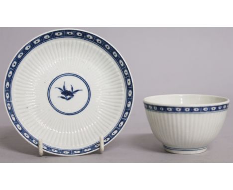AN 18TH CENTURY WORCESTER RARE TEA BOWL AND SAUCER painted with Fluted Dark Sprig Floral pattern.