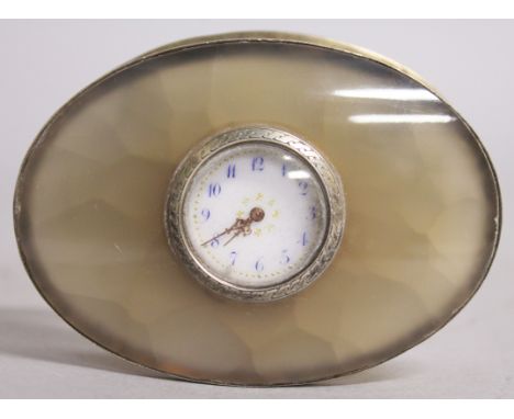 A SUPERB SMALL GREEN JADE AND SILVER OVAL CLOCK, on an unusual pierced rocking silver stand, in its original box, TONNEL P. L