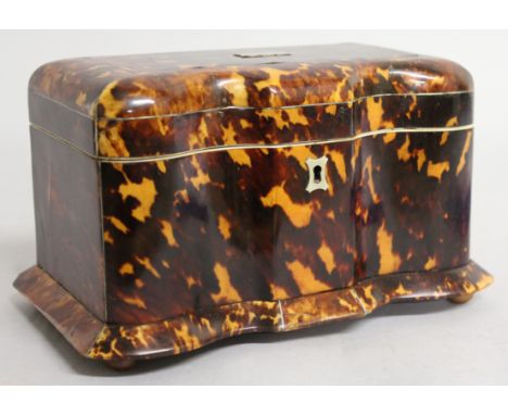 A GOOD REGENCY SHAPED FRONT TORTOISESHELL TWO DIVISION TEA CADDY with two fitted compartments with covers, supported on four 