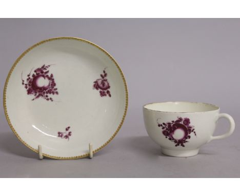 AN 18TH CENTURY WORCESTER TEACUP AND SAUCER painted with puce coloured fruit.