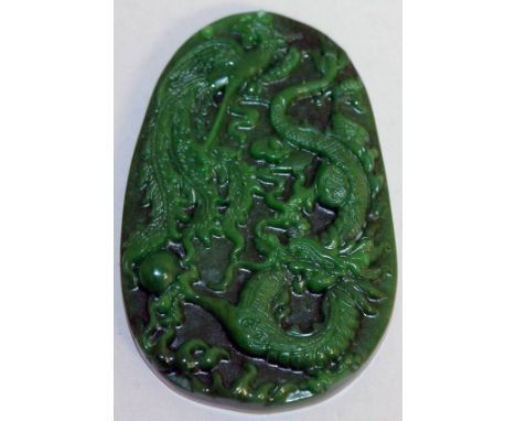 A GREEN JADE "DRAGON" PLAQUE.  3.5ins long.