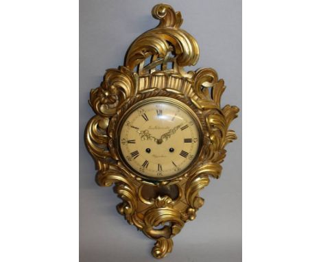 A GOOD CARVED AND GILDED CARTEL CLOCK by Em. Soder Lundo, Uppsala. 27ins high.