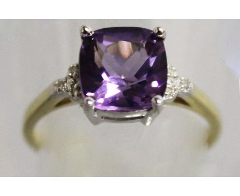 A 9CT YELLOW GOLD SQUARE AMETHYST RING, with diamond shoulders.