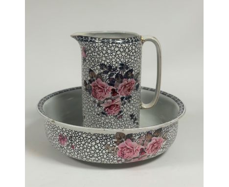 A Royal Staffordshire Pottery wash basin (w- 40cm) and water jug (h- 30cm) decorated with roses and a black and white backgro