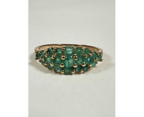 A 9ct gold emerald and diamond cluster ring, bombe, three rows of emeralds, with diamond points (P/Q), 1.95g