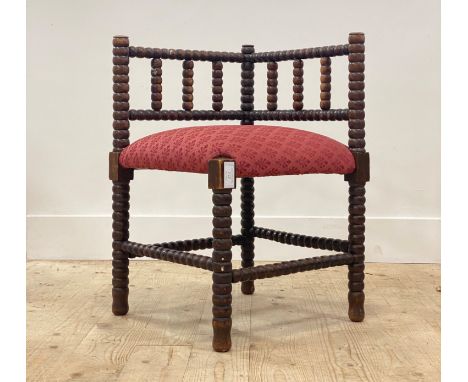 An early 20th century bobbin turned beech wood corner chair in the manner of William Morris, with upholstered seat. H65cm, W4