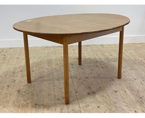 A mid 20th century elm and beech extending dining table, the oval top with magic leaf to centre raised on turned supports, by