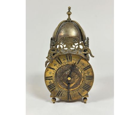 A reproduction brass lantern style clock with baluster finial and domed bell, with brass engraved surmount and dial by Mouret