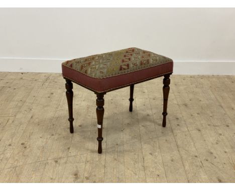 A Victorian rosewood framed stool, the top covered in needlepoint fabric worked in a geometric design, with red panelled side