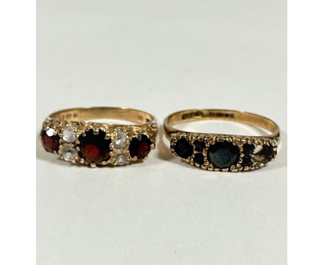 A three stone graduated garnet set 9ct gold ring, mounted with cz spacers (O/P) and a 9ct gold two stone sapphire ring, missi