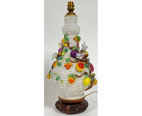 A large Meissen marked Schneeballen vase converted to a lamp base decorated with fruits and birds and encrusted with flowers 