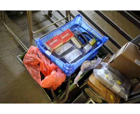 A box containing various tools, watering cans, staple gun etc.