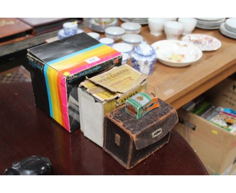 A Polaroid camera, a Brownie box camera, an Agfa camera and a Coronet Midget camera
