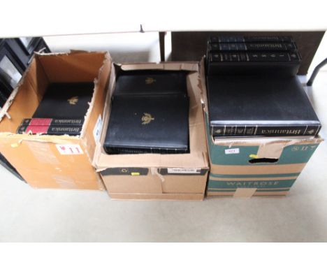 Three boxes of Encyclopedia Britannica and two photo frames