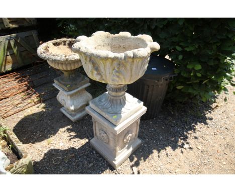 A concrete garden planter, raised on plinths