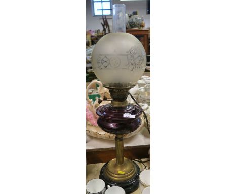 An oil lamp, with ruby glass reserve and brass column