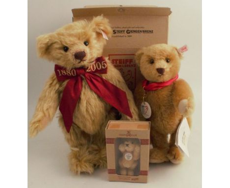 A modern Steiff teddy bear, in gold plush, wearing a red bow embroidered 1880 - 2005, height 13ins, together with two other S