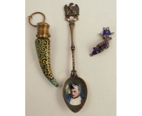 A gilt metal souvenir spoon, with enamel portrait of Nelson to the bowl, together with a metal and enamel articulated fish an