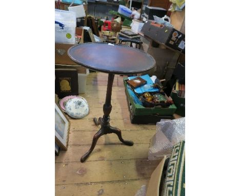 A mahogany tripod table