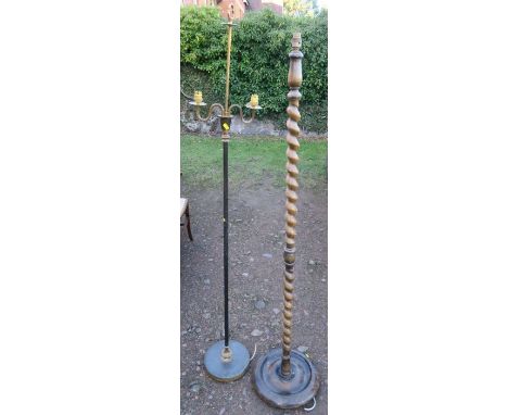 A brass lamp standard, with two branches, together with a barley twist lamp standard and another