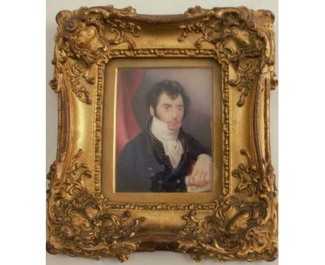 A 19th century portrait miniature, painted on ivory of a man holding a rolled piece of music, 3.5ins x 2.5ins, the back with 