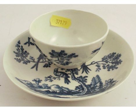 A first period Worcester tea bowl and saucer, decorated in the Birds in Branches pattern, crescent mark to base