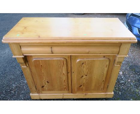 A 19th century pine chiffonier, fitted with one longer frieze drawer, over two panel doors, width 43ins