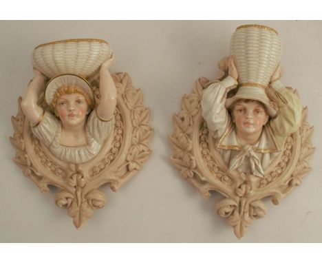 A pair of 19th century Royal Worcester wall pockets, modelled as Kate Greenway style children holding a basket, shape numbers
