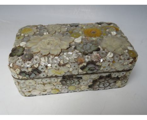 A DECORATIVE ORIENTAL LACQUER WARE LIDDED BOX, with extensive mother of pearl floral embellishment, 15.5 x 9.5 x 6 cm S/D