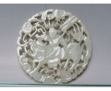 AN ORIENTAL RETICULATED CIRCULAR JADE PANEL, depicting a figure on horseback, Dia. 5.5 cm