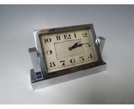 A FORTNUM &amp; MASON ART DECO CHROMED TABLE CLOCK, the rectangular clock face swivelling on two supports, 8 day movement, H 