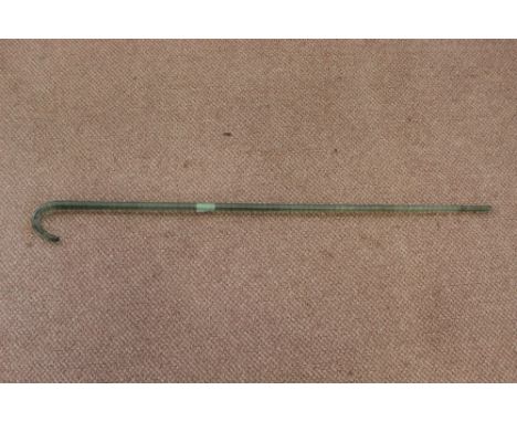 A green spiral glass walking stick