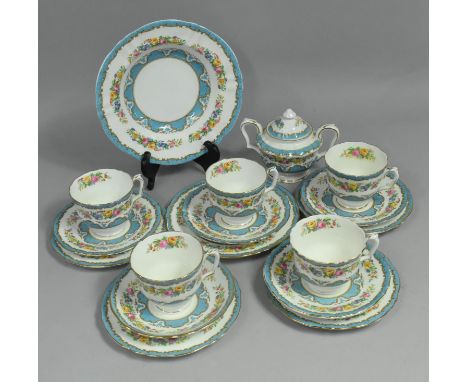 A Royal Staffordshire Tea Set decorated with Blue Scrolls, Gilt Trim and Floral Swag to comprise Five Cups, Saucers and Side 