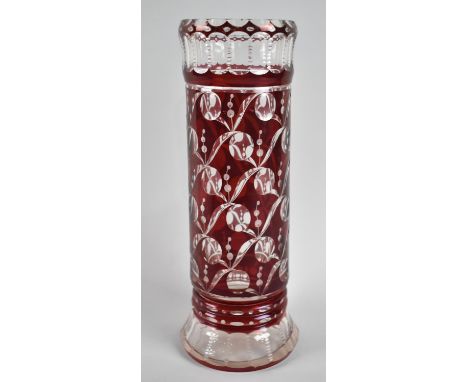 An Art Deco Bohemian Overlaid Ruby Glass Cylindrical Vase, Cut with Stylised Patterns of Leaves and Fruits, 28cm high 