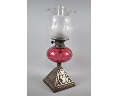 A Late Victorian/Edwardian Iron Based Oil Lamp, The Four Sides of base decorated with Maidens representing the Four Seasons, 