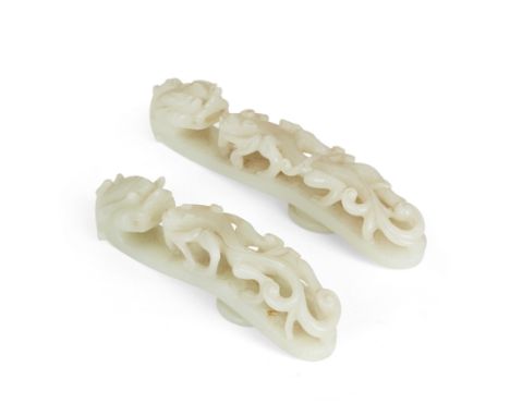 Two large Chinese pale jade 'dragon' belt hooksQing dynasty, 18th/19th and 19th/20th centuryThe larger belt hook carved from 