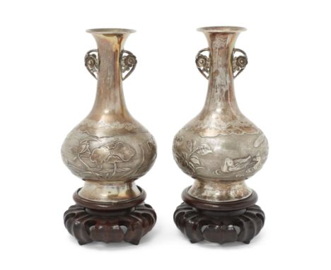 A pair of Chinese silver pear-shaped vasesLate Qing dynasty, circa 1900With reticulated 'prunus' handles, the globular bodies