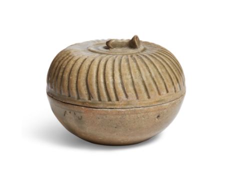 A Chinese Yueyao green-glazed box and carved coverFive dynastiesThe cover carved as a lobed melon and topped with stem-shaped