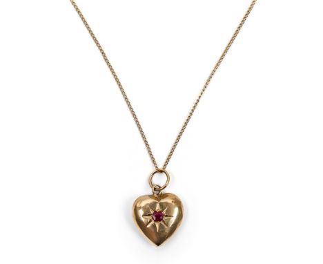 A Chinese gold ruby-inset heart-shaped pendantEarly 20th century The hollow pendant shaped as a heart, inset to the centre wi