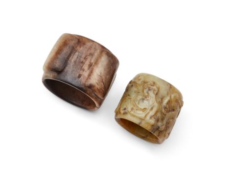 A Chinese carved jade cong and a carved jade thumb ringQing dynasty and laterThe first carved from a mushroom and black mottl