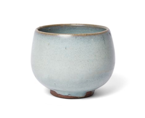 A Chinese Jun-style deep cup20th centuryThe vessel with deep rounded sides covered in a thick, glassy, pale blue glaze stoppi
