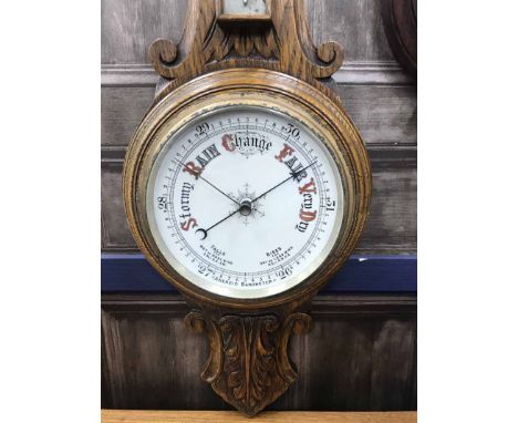 TWO CARVED WHEEL BAROMETERS one with a silvered, the other with an enamel dial
