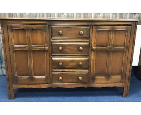 ERCOL SIDEBOARD fitted with four drawers flanked by two cupboard doors