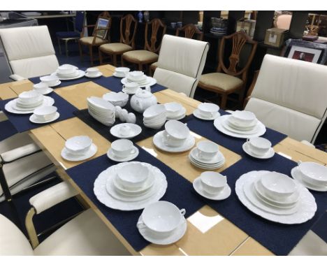 COALPORT DINNER SERVICE comprising leaf-decorated dinner plates, dessert plates, bowls, cups and saucers and a teapot