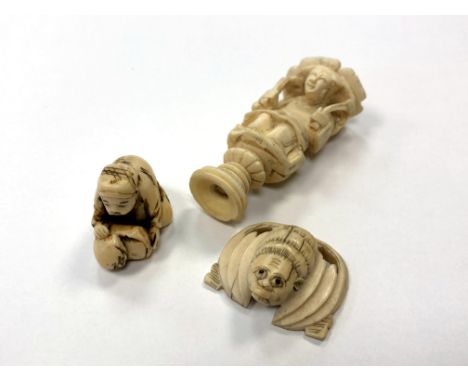 A Japanese ivory netsuke, a carved ivory buckle and one further carving. 