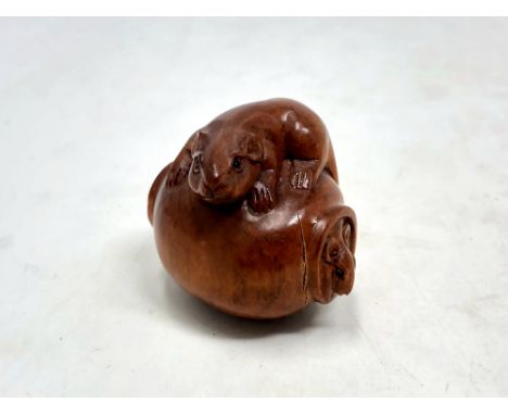 A Japanese carved fruitwood netsuke -  Rats on a barrel. 