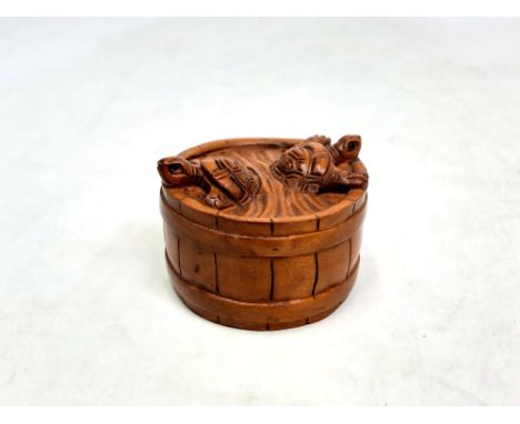 A Japanese carved fruitwood netsuke - Two turtles on a barrel. 