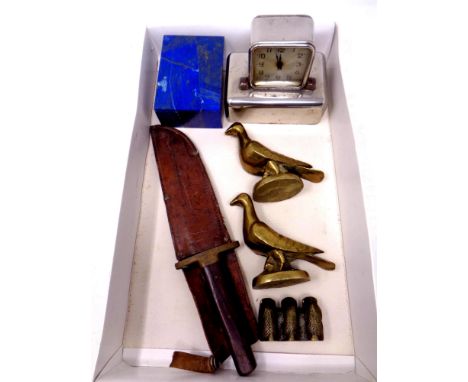 A box containing a vintage hunting knife in leather sheath, a pair of brass ornaments, pigeons, together with a pair of brass