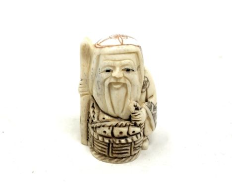 A Japanese carved bone netsuke - Village elder with a basket at his feet. 