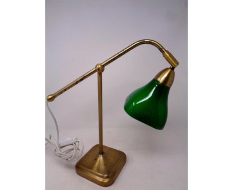A retro style metal desk lamp with green glass shade on weighted base  